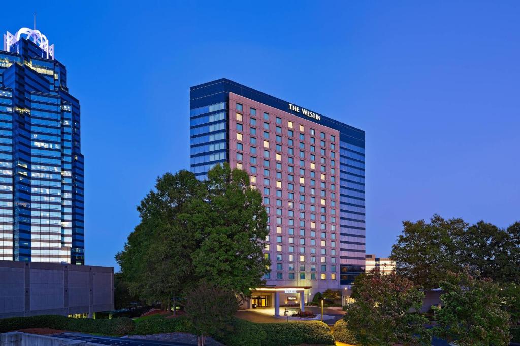 a tall building with lights on in a city at The Westin Atlanta Perimeter North in Atlanta