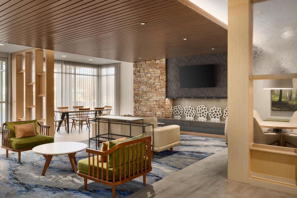 a lobby with a waiting area with chairs and a table at Fairfield by Marriott Inn & Suites Rockaway in Rockaway
