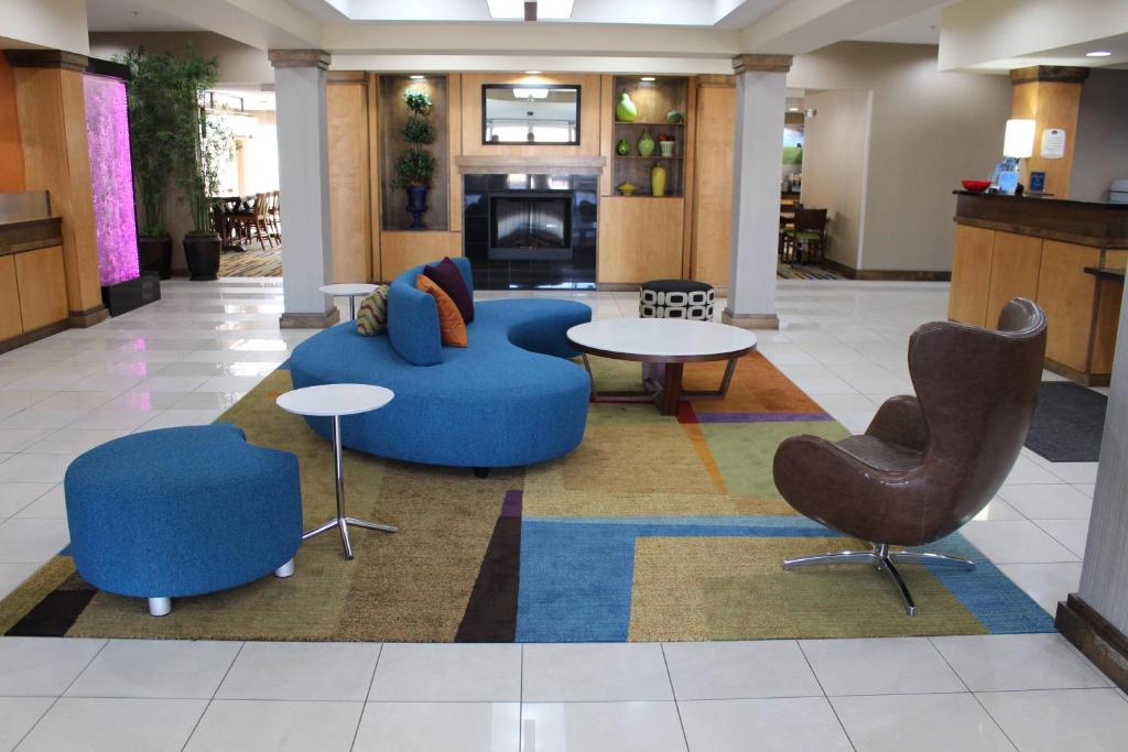 a lobby with couches and chairs and a table at Fairfield Inn & Suites Kansas City Liberty in Liberty