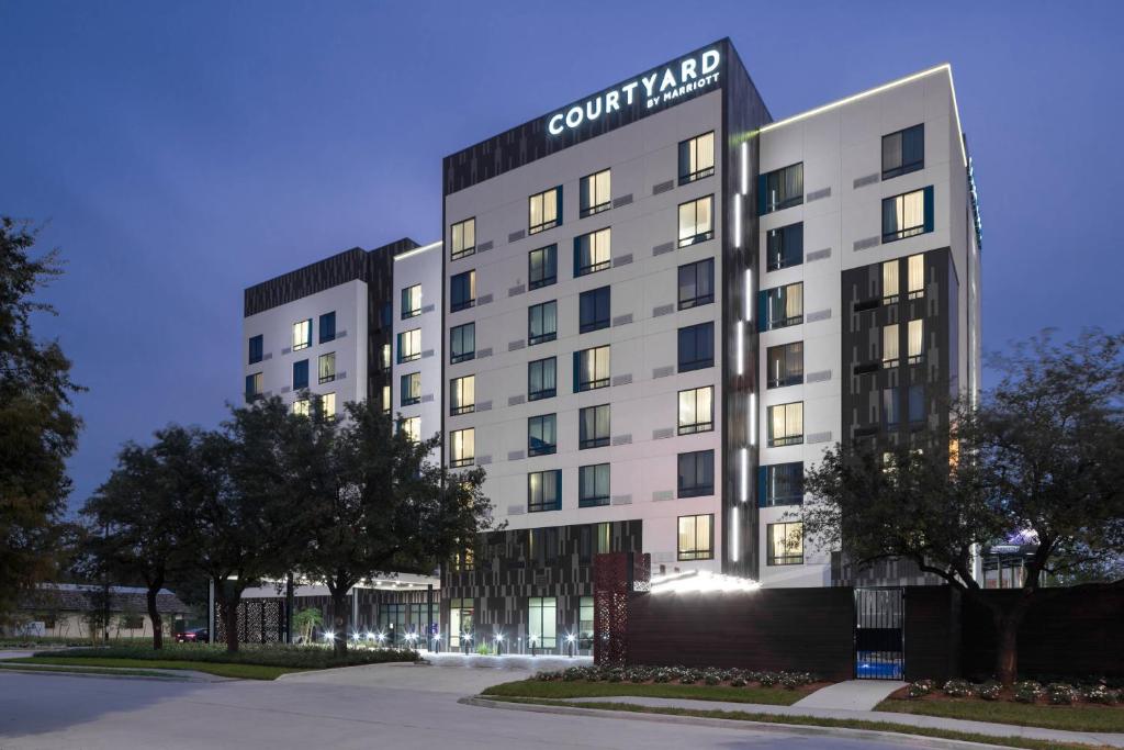 a building with a sign on the side of it at Courtyard by Marriott Houston Heights/I-10 in Houston