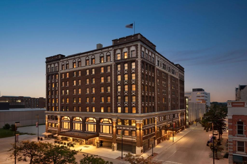 a large building with a flag on top of it at Hotel Northland, Autograph Collection in Green Bay