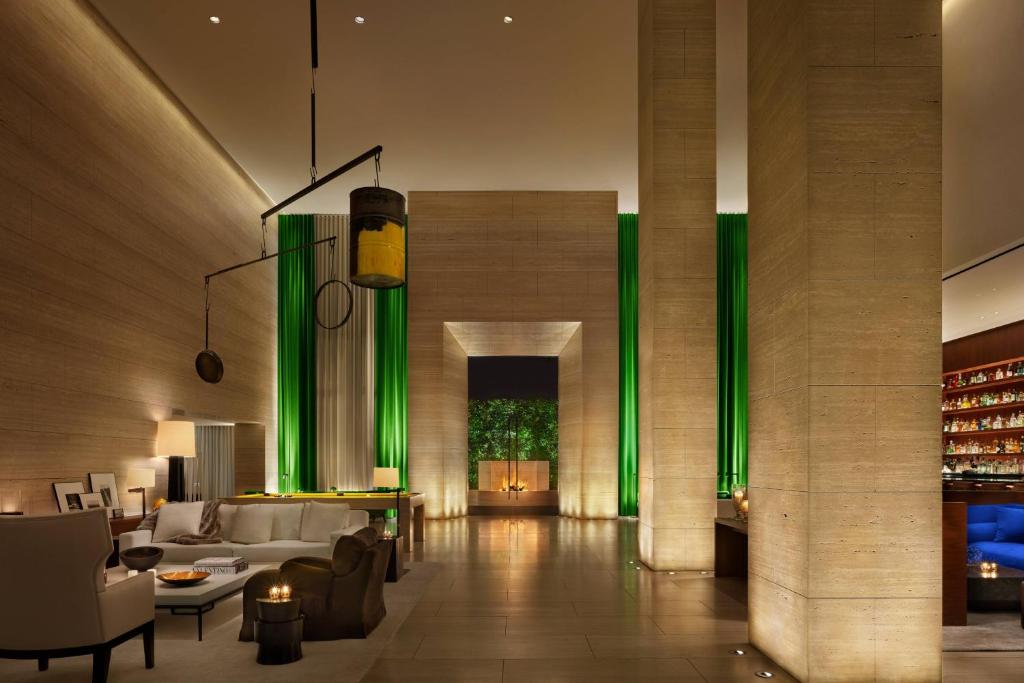 a living room with a white couch and green lighting at The West Hollywood EDITION in Los Angeles