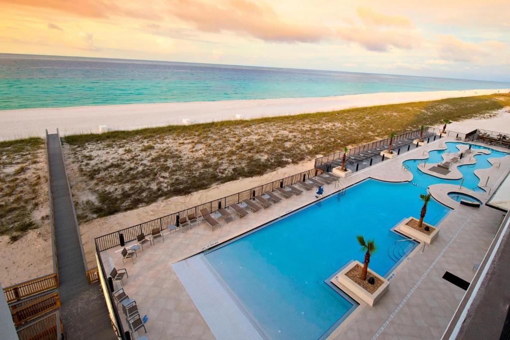 an overhead view of a swimming pool and the beach at SpringHill Suites by Marriott Navarre Beach in Navarre