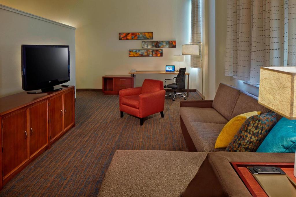 a living room with a couch and a television at Residence Inn by Marriott Hartford Downtown in Hartford