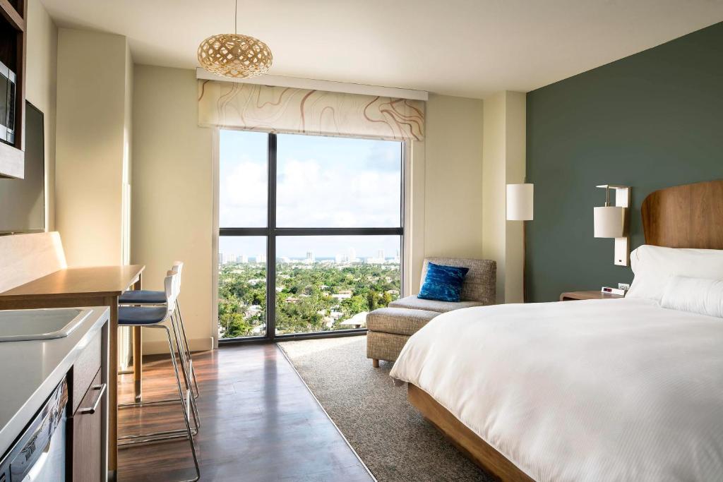 a hotel room with a bed and a large window at Element Fort Lauderdale Downtown in Fort Lauderdale