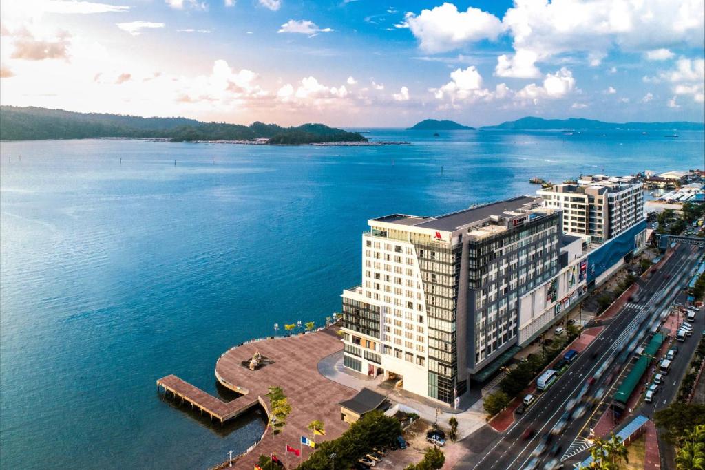 an aerial view of a building next to the water at Kota Kinabalu Marriott Hotel in Kota Kinabalu