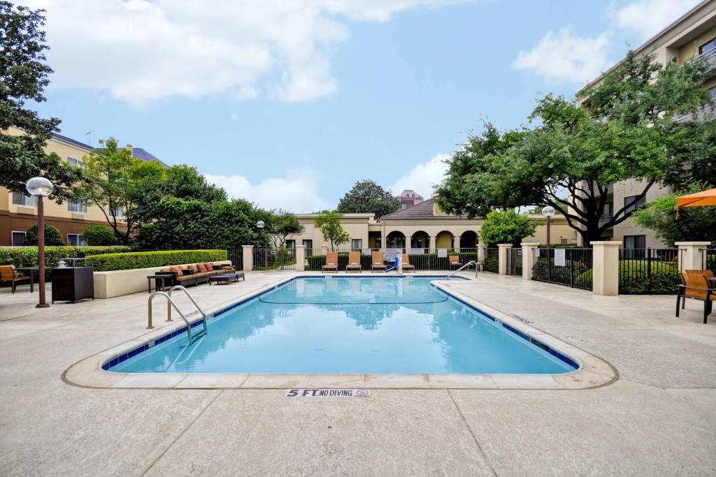 a swimming pool in the middle of a courtyard at Fairfield Inn & Suites Dallas Medical/Market Center in Dallas