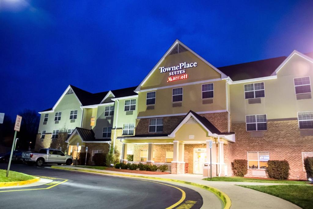 a front view of a hotel at night at TownePlace Suites Stafford in Stafford