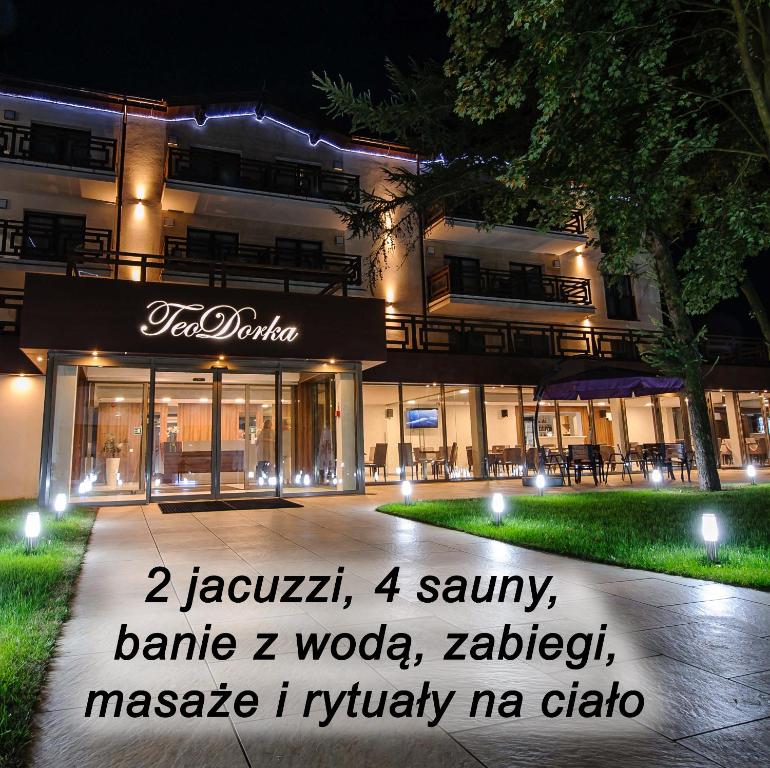 a building with a sign in front of it at night at TeoDorka Med & SPA in Ciechocinek