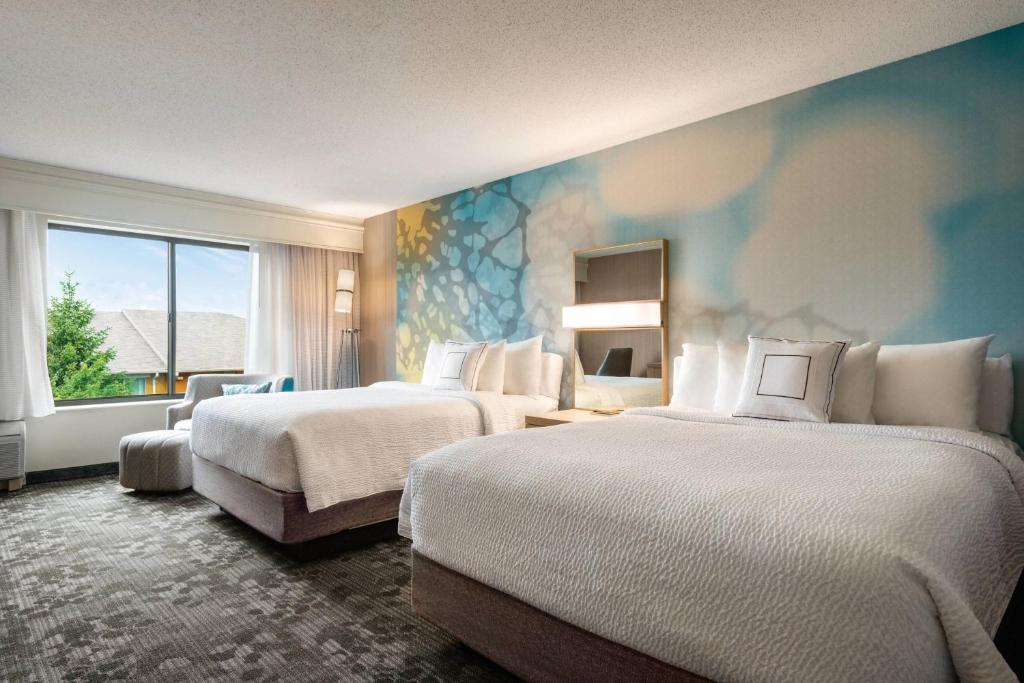 a hotel room with two beds and a window at Courtyard by Marriott Dayton North in Dayton