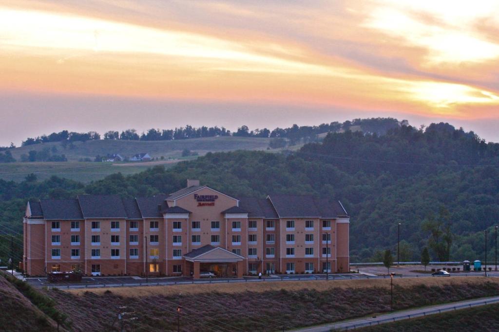 a large building with a sunset in the background at Fairfield Inn by Marriott Morgantown in Morgantown