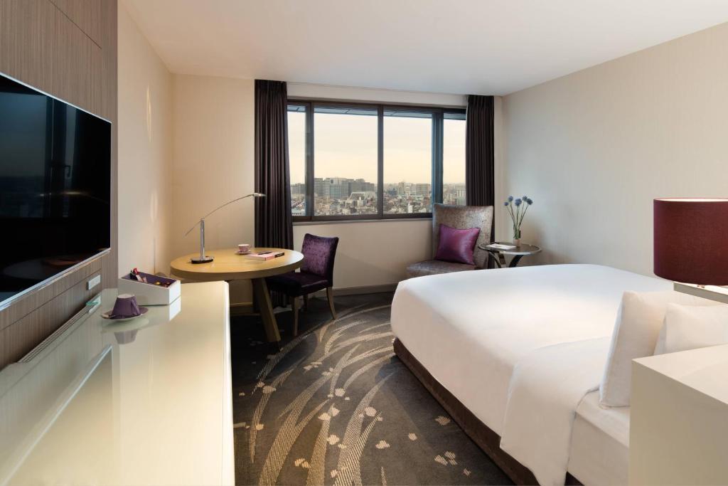 a hotel room with a large bed and a table at Tokyo Marriott Hotel in Tokyo