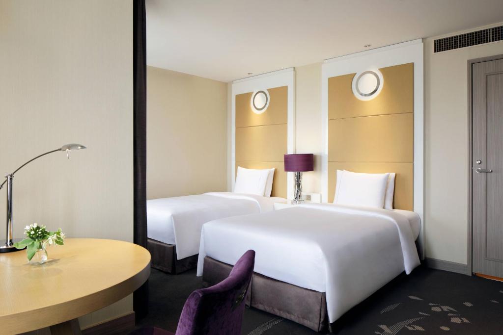 a hotel room with two beds and a table at Tokyo Marriott Hotel in Tokyo