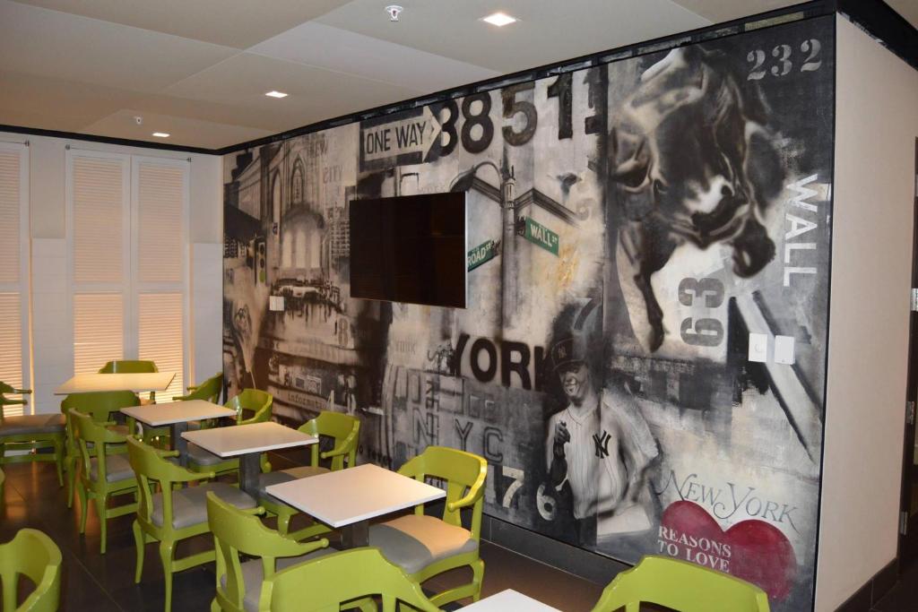 a classroom with tables and chairs and a large wall at Residence Inn by Marriott New York Downtown Manhattan/World Trade Center Area in New York