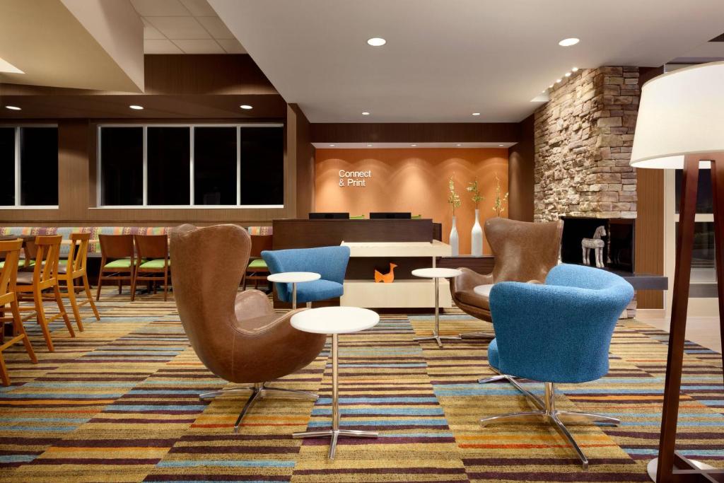 a lobby with chairs and tables and a fireplace at Fairfield Inn Philadelphia Valley Forge/King of Prussia in King of Prussia