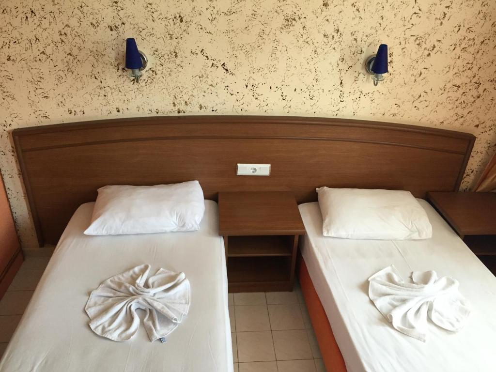 Postel nebo postele na pokoji v ubytování Baronessa Apart Hotel
