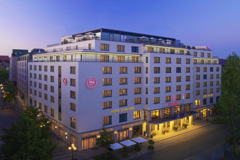 a rendering of a hotel at night at Sheraton Carlton Nuernberg in Nuremberg