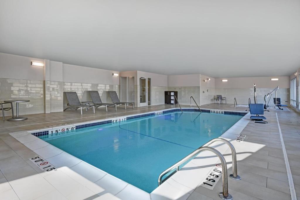 a large swimming pool in a hotel room at TownePlace Suites by Marriott Grand Rapids Wyoming in Wyoming