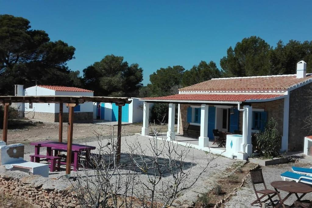 a house with a table and chairs in front of it at CAN JAUME D’EN PEP MIQUEL in Sant Francesc Xavier