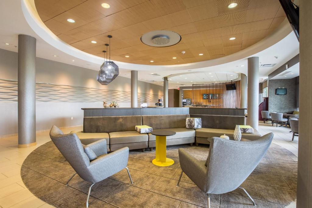 a lobby of a hotel with chairs and a table at SpringHill Suites by Marriott Houston Rosenberg in Rosenberg