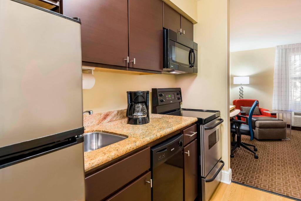 a kitchen with a sink and a microwave at TownePlace Suites Tampa Westshore/Airport in Tampa