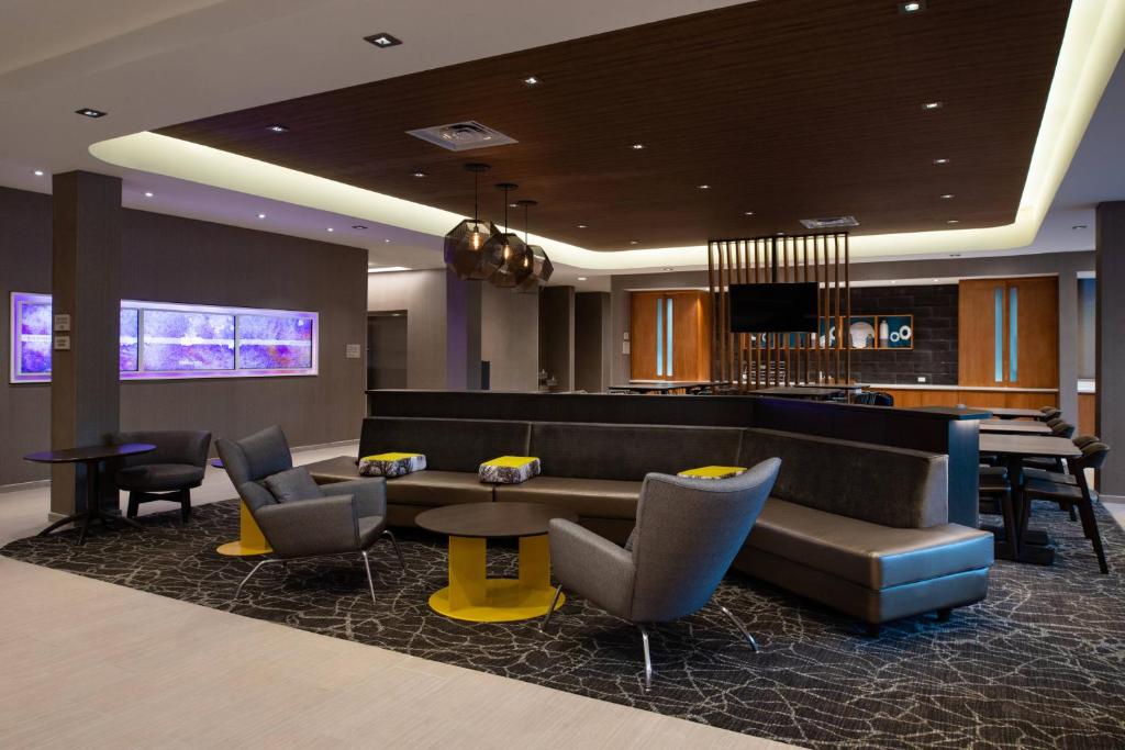 a lobby with a couch and chairs and a bar at SpringHill Suites by Marriott Elizabethtown in Elizabethtown