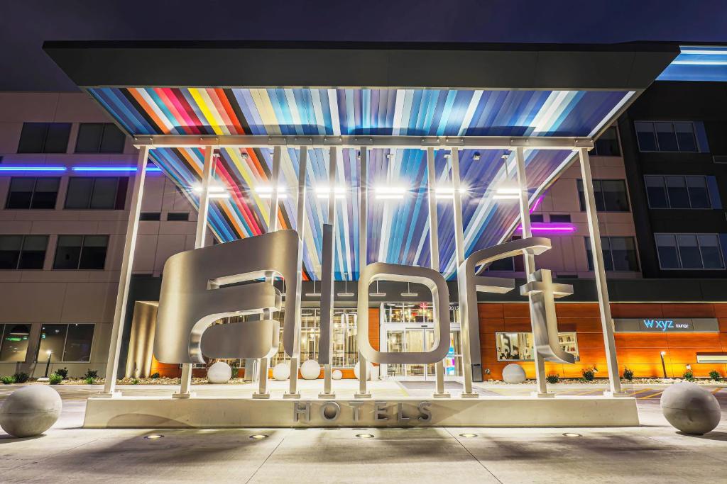 a group of chairs in front of a building at Aloft by Marriott Reno Tahoe International Airport in Reno