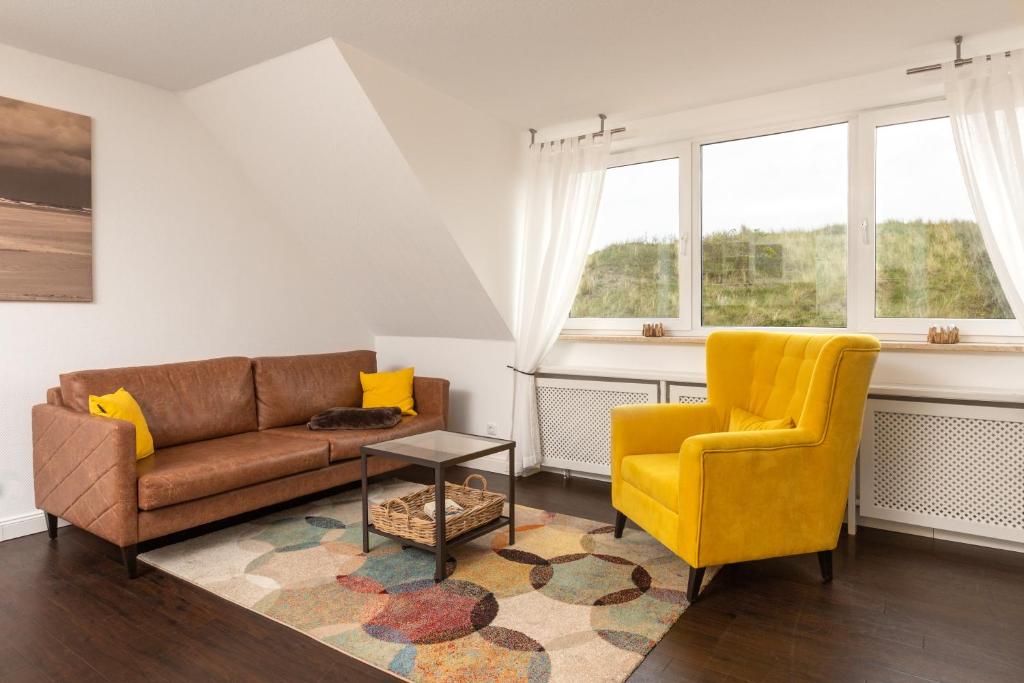 a living room with a couch and a chair at Wohnung Bontje in Juist