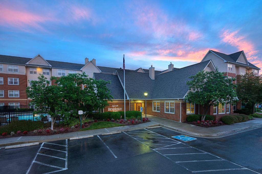 a building with a parking lot in front of it at Residence Inn Richmond Northwest in Broad Meadows