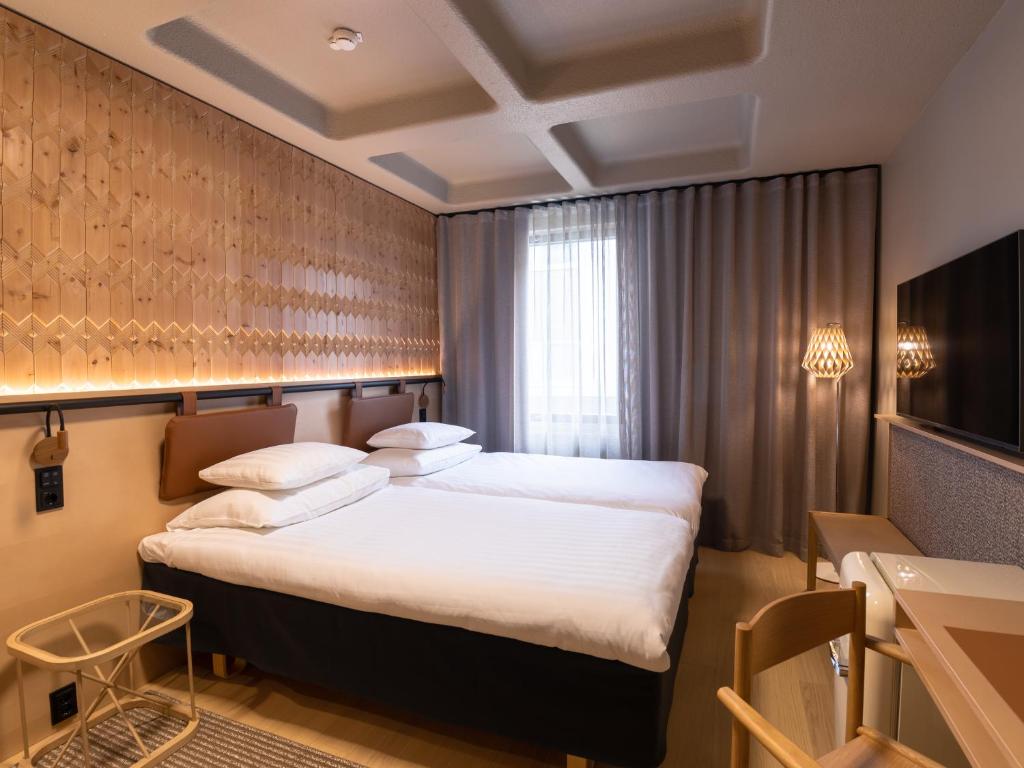 Original Sokos Hotel Lappee tesisinde bir odada yatak veya yataklar