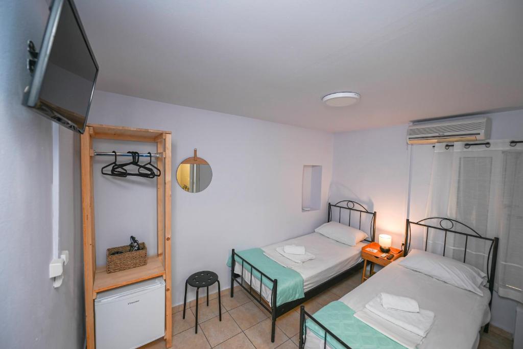 Postel nebo postele na pokoji v ubytování Hermes Rooms