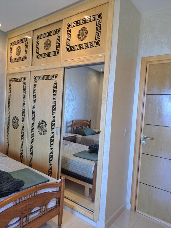 a bedroom with a mirror and a bed in a room at Blue Horizon-Ghougine in Tangier