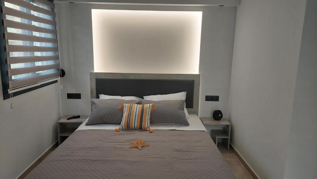 a bedroom with a large bed with two pillows on it at Luana Monte Apartments in Amoudara Herakliou