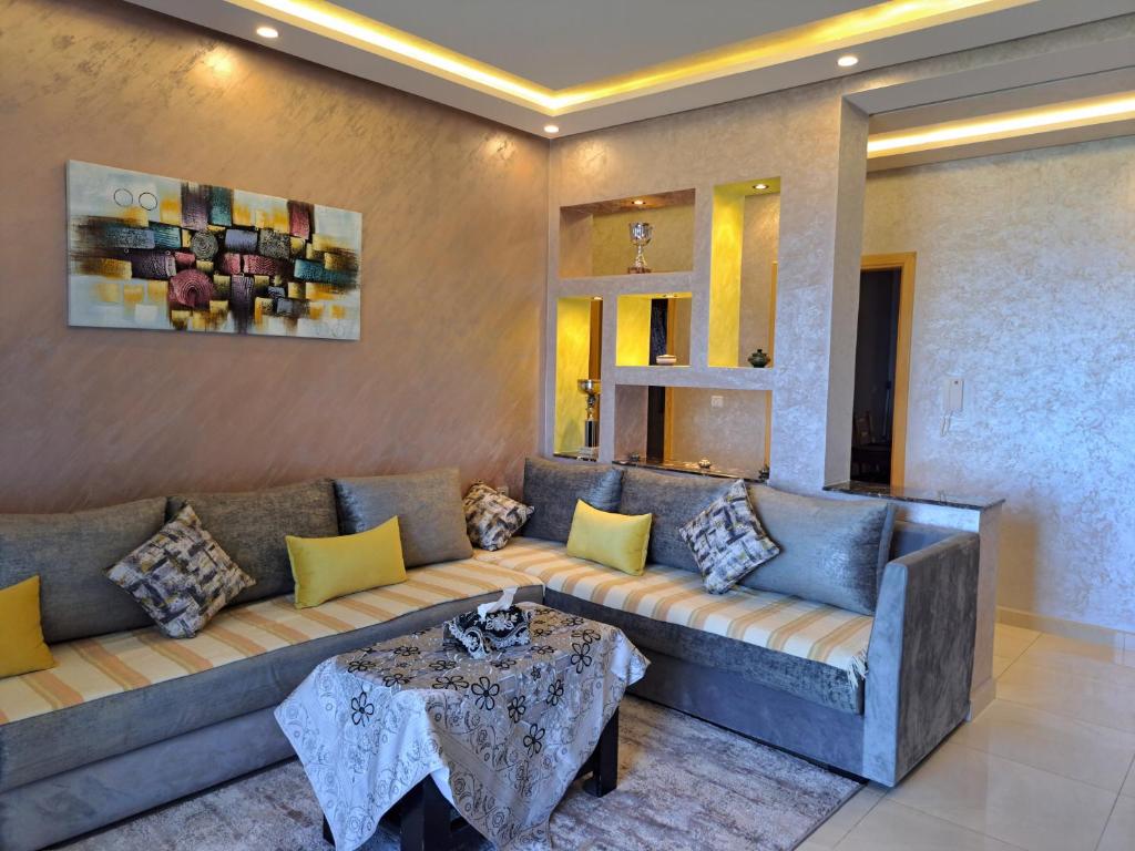 a living room with a couch and a table at Blue Horizon-Ghougine in Tangier