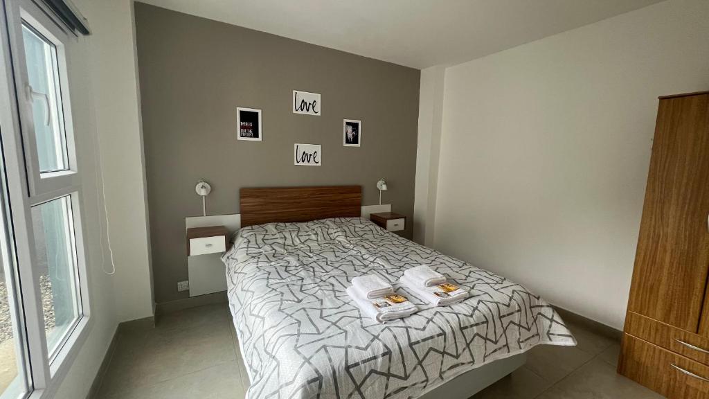 Un dormitorio con una cama con dos toallas encima. en Depto Magallanes, en Ushuaia