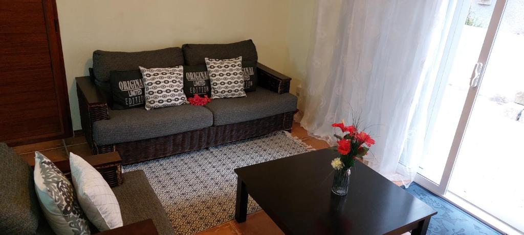 a living room with a couch and a table at Le Chaleureux in La Gaulette