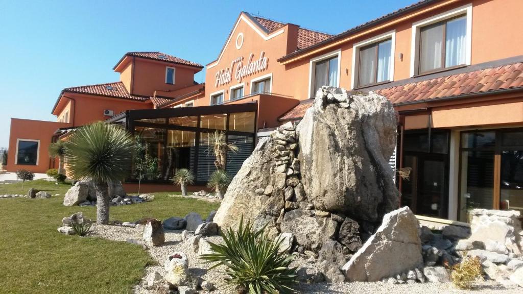 un grand rocher devant un bâtiment dans l'établissement Hotel Galanta, à Galanta