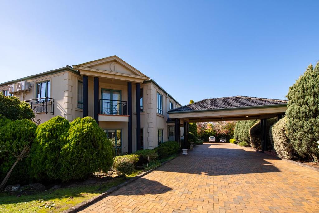 a house with a brick driveway in front of it at Gateway on Monash in Clayton North