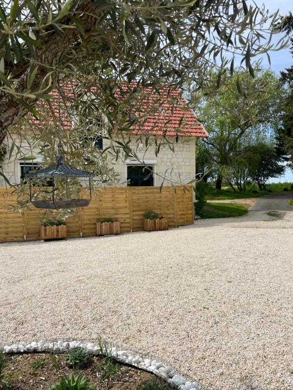 a house with a fence in front of it at Le Relais, La Dormance, Le Bois Dormant in Châteauvieux