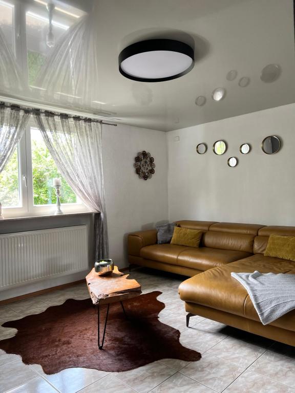ein Wohnzimmer mit einem Sofa und einem Tisch in der Unterkunft LifeStyle Apartment Sinsheim in Sinsheim