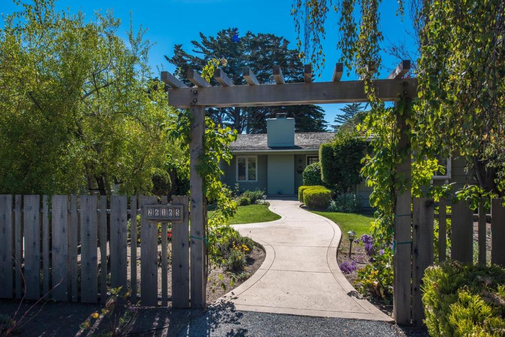 a garden with a wooden gate and a walkway at 3757 Garden House Sanctuary home in Carmel