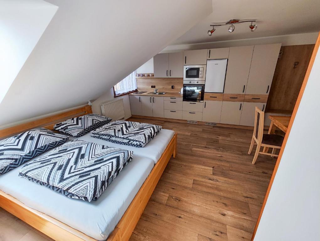 1 dormitorio con 1 cama grande y cocina en Malostranská restaurace, en Lišov