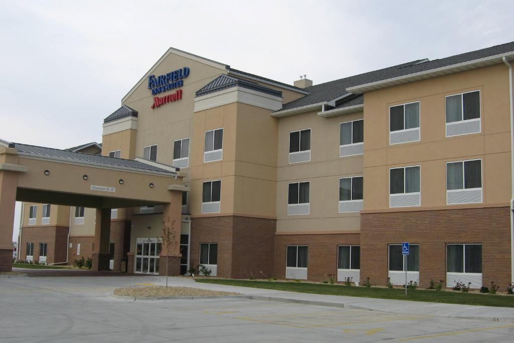 a hotel building with a sign on the front of it at Fairfield Inn & Suites Ames in Ames