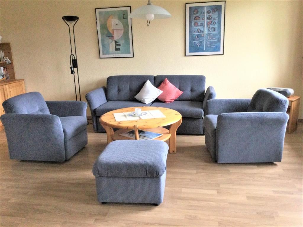 a living room with two couches and a table at Wohnpark Schmiedestraße App 16 in Wustrow