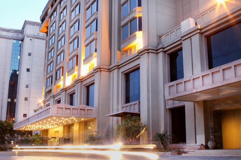 a large building with lights in front of it at The Metropolitan Hotel & Spa New Delhi in New Delhi