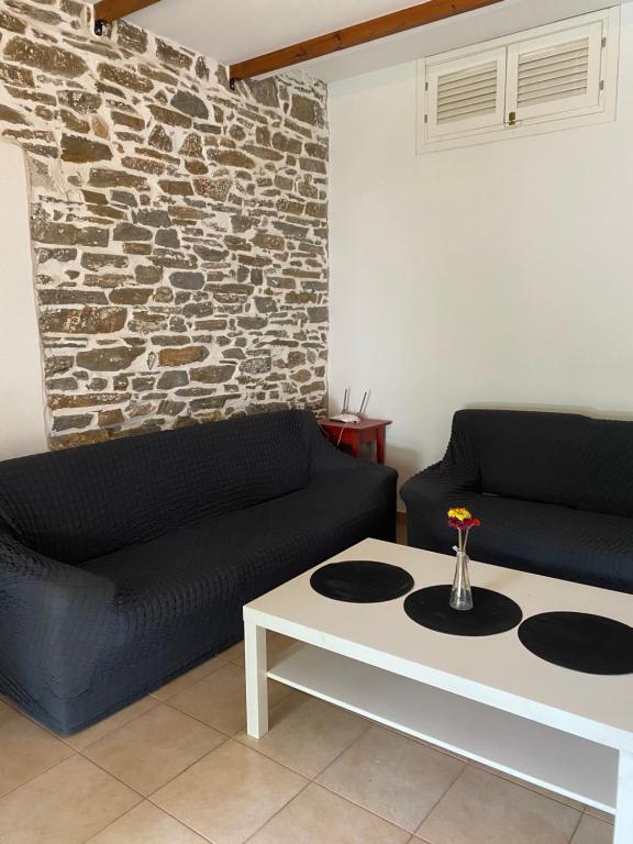 a living room with a couch and a coffee table at Petrino in Ayios Nikolaos Sithonia