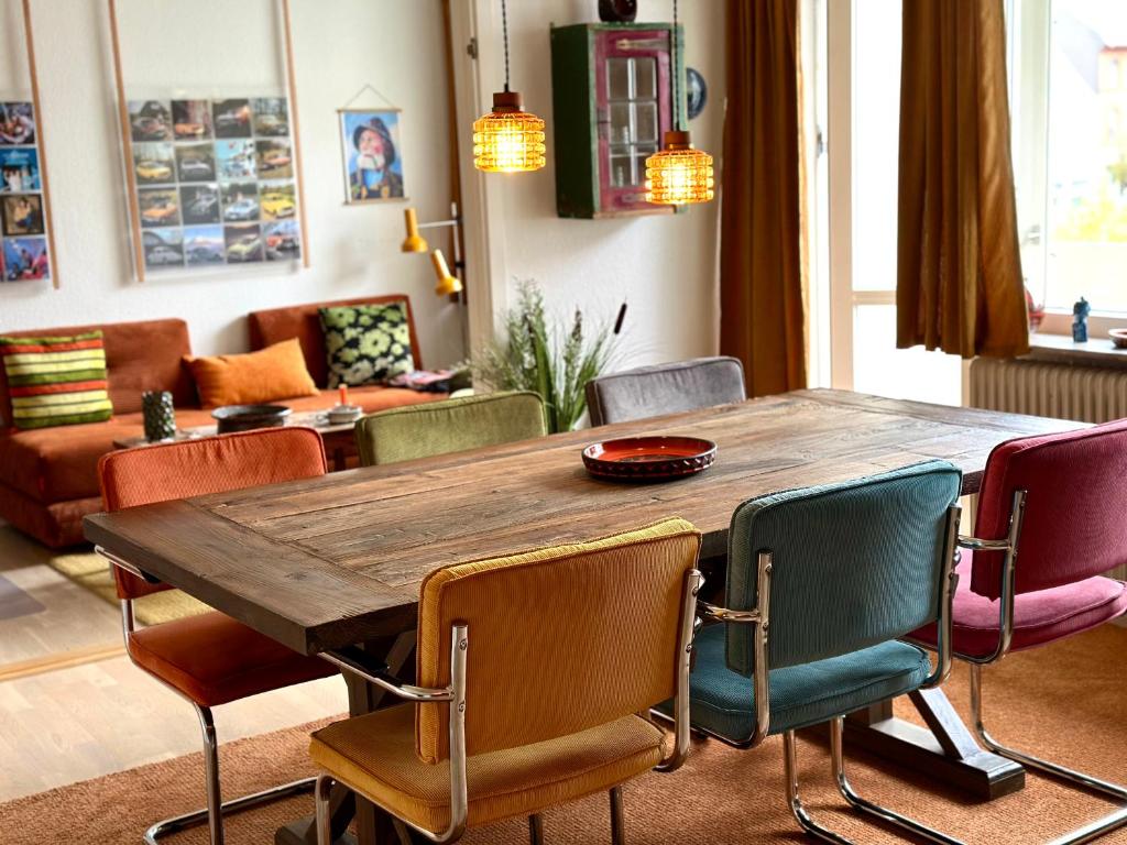 a wooden table and chairs in a living room at 2 værelses retro lejlighed på Torvet in Horsens