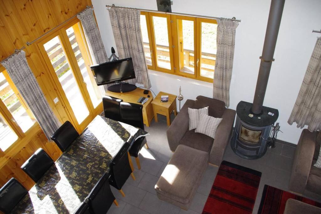 an overhead view of a living room with a couch and a tv at Chalet Mille Étoiles in Zinal