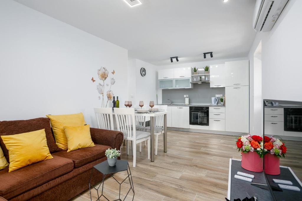 a living room and kitchen with a couch and a table at Apartment Ivana in Malinska