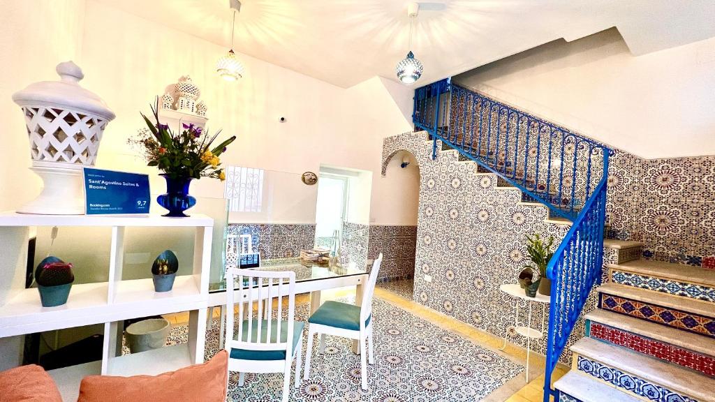 a living room with a staircase with blue and white tiles at Sant'Agostino Suites & Rooms in Mazara del Vallo